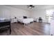 Bedroom with hardwood flooring, a ceiling fan, a window, and a desk at 2984 Sanctuary Dr, Clermont, FL 34714