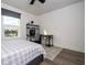 Cozy bedroom with a gray wood floor, desk with computer, and great natural light at 2984 Sanctuary Dr, Clermont, FL 34714