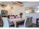 Elegant dining room with hardwood floors, modern lighting, and a stylish table setting at 2984 Sanctuary Dr, Clermont, FL 34714