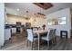 Dining area with a table, chairs, and a view of the kitchen with stainless steel appliances at 2984 Sanctuary Dr, Clermont, FL 34714