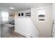 Hallway featuring gray wood floors, white walls, and modern decor with a view to the living area at 2984 Sanctuary Dr, Clermont, FL 34714