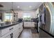Bright kitchen with stainless steel appliances, white cabinetry, and a modern design at 2984 Sanctuary Dr, Clermont, FL 34714