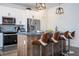 Kitchen with stainless steel appliances, a kitchen island with seating, and modern pendant lighting at 2984 Sanctuary Dr, Clermont, FL 34714