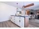 Spacious kitchen island with modern lighting, hardwood floors, and seating at 2984 Sanctuary Dr, Clermont, FL 34714