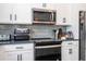 Well-equipped kitchen with stainless steel appliances, tiled backsplash, and a modern range at 2984 Sanctuary Dr, Clermont, FL 34714