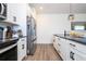 Bright kitchen features white cabinets, stainless steel appliances, and modern hardware at 2984 Sanctuary Dr, Clermont, FL 34714