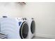 Modern laundry room featuring a front-load washer and dryer set at 2984 Sanctuary Dr, Clermont, FL 34714