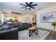 Comfortable living room showcasing a gray sectional sofa, contemporary decor, and hardwood floors at 2984 Sanctuary Dr, Clermont, FL 34714