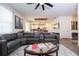 Open-concept living space with a large sectional sofa, views of the kitchen, and stylish decor at 2984 Sanctuary Dr, Clermont, FL 34714
