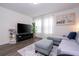 Comfortable living room features a large screen TV, modern furniture, and a bright ambiance at 2984 Sanctuary Dr, Clermont, FL 34714