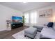 Comfortable living room features a large screen TV, modern furniture, and a bright ambiance at 2984 Sanctuary Dr, Clermont, FL 34714