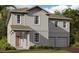 Charming two-story home featuring neutral siding, covered entry, manicured lawn and a two-car garage at 30113 Misty Pines Rd, Mount Dora, FL 32757