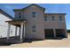 Two-story home featuring a two-car garage, covered front porch, and light-colored siding at 30113 Misty Pines Rd, Mount Dora, FL 32757