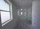 Unfinished hallway with bright natural light and several windows and light-colored walls at 30113 Misty Pines Rd, Mount Dora, FL 32757