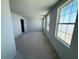 Spacious living room with large windows, allowing for ample natural light and comfortable living space at 30113 Misty Pines Rd, Mount Dora, FL 32757