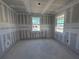 Bedroom under construction, featuring drywall and windows with natural light, ready for personalization at 30158 Rustic Mill St, Mount Dora, FL 32757