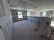 A large bonus room on the second floor with multiple windows for natural light at 30158 Rustic Mill St, Mount Dora, FL 32757