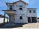 Two-story home under construction featuring windows and covered porch with construction materials and builder's logo at 30158 Rustic Mill St, Mount Dora, FL 32757
