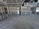 Interior view of a new home under construction, showcasing a spacious layout with drywall and open doorway at 30158 Rustic Mill St, Mount Dora, FL 32757