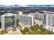 High-rise condo with a rooftop swimming pool surrounded by mature trees and city skyline at 322 E Central Blvd # 1910, Orlando, FL 32801
