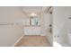 Well-lit bathroom with tile flooring, bath tub, and a vanity with storage at 322 E Central Blvd # 1910, Orlando, FL 32801