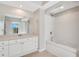 Bright bathroom with a soaking tub, white cabinets, and large mirror providing a comfortable space at 322 E Central Blvd # 1910, Orlando, FL 32801