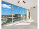 Bright bedroom featuring a ceiling fan, large windows offering a city view, and neutral carpet at 322 E Central Blvd # 1910, Orlando, FL 32801