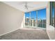 Cozy bedroom featuring a ceiling fan and a large window offering city views at 322 E Central Blvd # 1910, Orlando, FL 32801