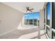Bright bedroom features a ceiling fan, carpet, and expansive windows with city views, creating a serene space at 322 E Central Blvd # 1910, Orlando, FL 32801