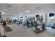 Spacious gym with elliptical machines, treadmills, flat-screen TVs, and floor-to-ceiling windows at 322 E Central Blvd # 1910, Orlando, FL 32801