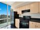 Kitchen featuring light wood cabinets, black countertop, and a great view at 322 E Central Blvd # 1910, Orlando, FL 32801