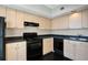 Efficient kitchen featuring light wood cabinetry, black appliances, and dark countertops for a modern look at 322 E Central Blvd # 1910, Orlando, FL 32801