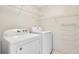 A compact laundry room featuring a Whirlpool washer and dryer, and wire shelving for organized storage at 322 E Central Blvd # 1910, Orlando, FL 32801