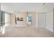 Bright, carpeted living space with track lighting and an open view into the kitchen and balcony access at 322 E Central Blvd # 1910, Orlando, FL 32801