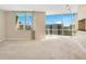 Bright living room with carpeted floors, large windows, and a view of city buildings under a sunny sky at 322 E Central Blvd # 1910, Orlando, FL 32801