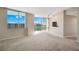 Sunlit living room with floor-to-ceiling windows offering cityscape views, plush carpet, and stylish track lighting at 322 E Central Blvd # 1910, Orlando, FL 32801