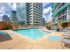 Modern swimming pool with city views, lounge chairs, and a covered seating area at 322 E Central Blvd # 1910, Orlando, FL 32801
