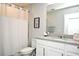 Bathroom featuring a shower with white curtain, a toilet, and a vanity with white cabinets at 3237 Palatka St, Orlando, FL 32824