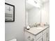 Bathroom featuring white cabinets, a stone counter, vanity with sink, and a mirror above the sink at 3237 Palatka St, Orlando, FL 32824