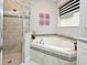 Bathroom featuring a glass-enclosed shower and a relaxing soaking tub at 3237 Palatka St, Orlando, FL 32824