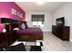 Comfortable bedroom with a purple accent wall, a large window, and a dresser at 3237 Palatka St, Orlando, FL 32824