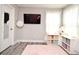 Bedroom featuring bright curtains, a TV, a plush rug, and built-in shelving by the window at 3237 Palatka St, Orlando, FL 32824