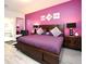 Bedroom with a luxurious king-size bed, accent wall, and stylish decor at 3237 Palatka St, Orlando, FL 32824