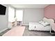 Bedroom with gray walls, a pink accent wall, curtains, a TV, a bed, and a pink rug at 3237 Palatka St, Orlando, FL 32824