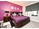Bedroom with a luxurious king-size bed, accent wall, and stylish decor for a restful retreat at 3237 Palatka St, Orlando, FL 32824