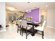 Stylish dining area features a modern light fixture, contemporary furniture, and a vibrant purple accent wall at 3237 Palatka St, Orlando, FL 32824