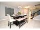Dining room with a modern chandelier, large window, and dining table with chairs and bench at 3237 Palatka St, Orlando, FL 32824
