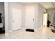 Entryway featuring white doors, tile flooring, and salon area with mirror and styling chair at 3237 Palatka St, Orlando, FL 32824