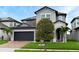 Charming two-story home featuring a brick driveway, two-car garage and lush landscaping at 3237 Palatka St, Orlando, FL 32824