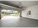 Garage with epoxy flooring and open door showcasing the exterior street view at 3237 Palatka St, Orlando, FL 32824